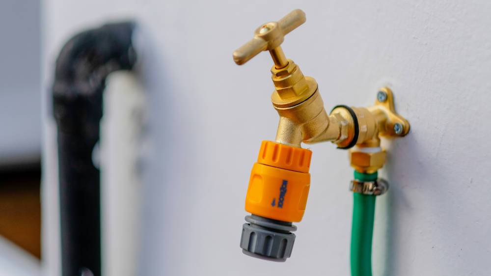Outside tap with a hosepipe attachment.