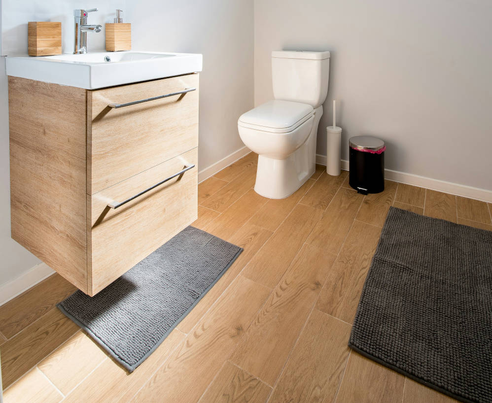 A picture of a neat bathroom, with a floating vanity unity sink.
